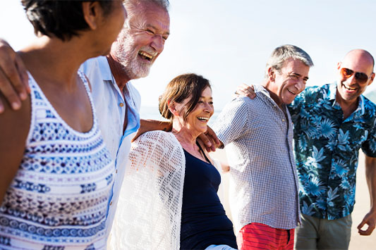 Group of Adults at the Beach Together Happy